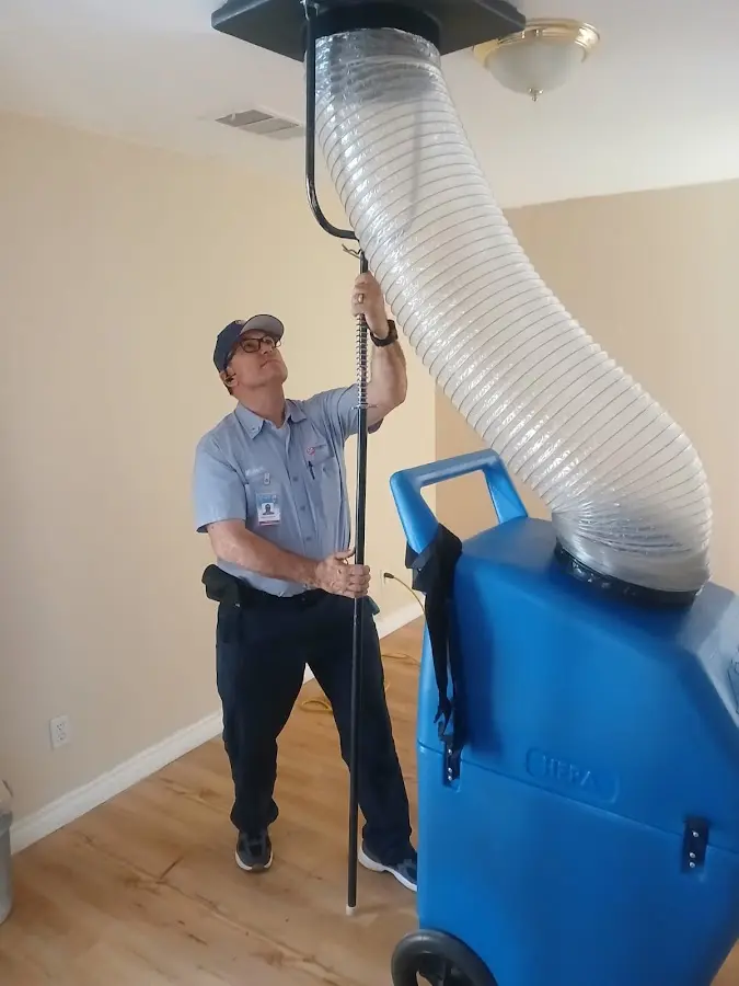 Furnace Tune-Up technician using HEPA equipment in Deming